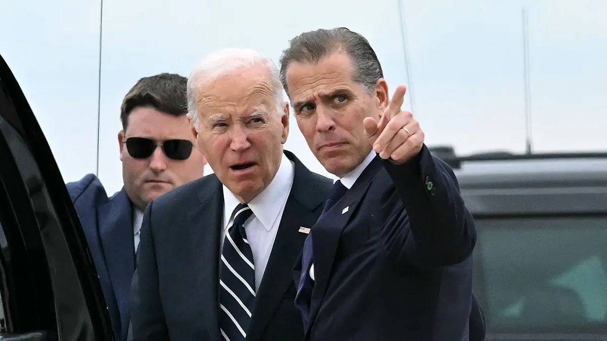 President Joe Biden talks with his son Hunter Biden at Delaware Air National Guard Base