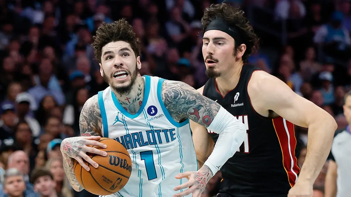 Charlotte Hornets guard LaMelo Ball driving to the basket against Miami Heat forward Jaime Jaquez Jr.