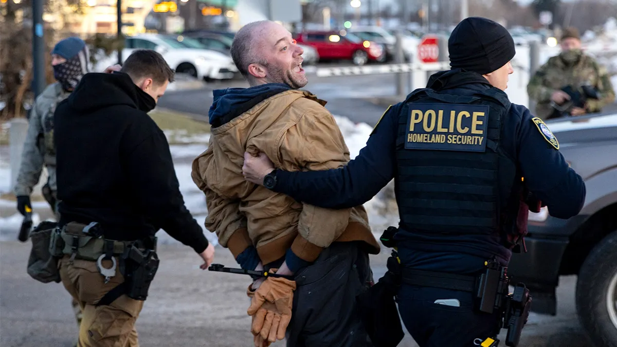 Federal agents arrest an anti-ICE agitator outside an ICE facility in Minneapolis.