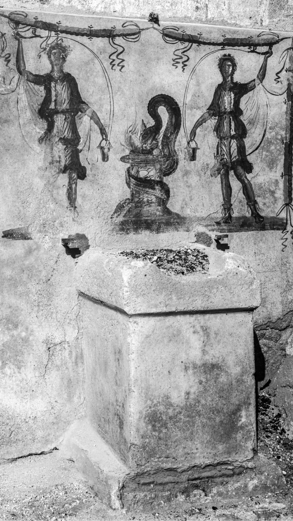 Pompeian street altar with painted images of gods and ash residues from the last sacrifice performed there. Photo from 1915.
