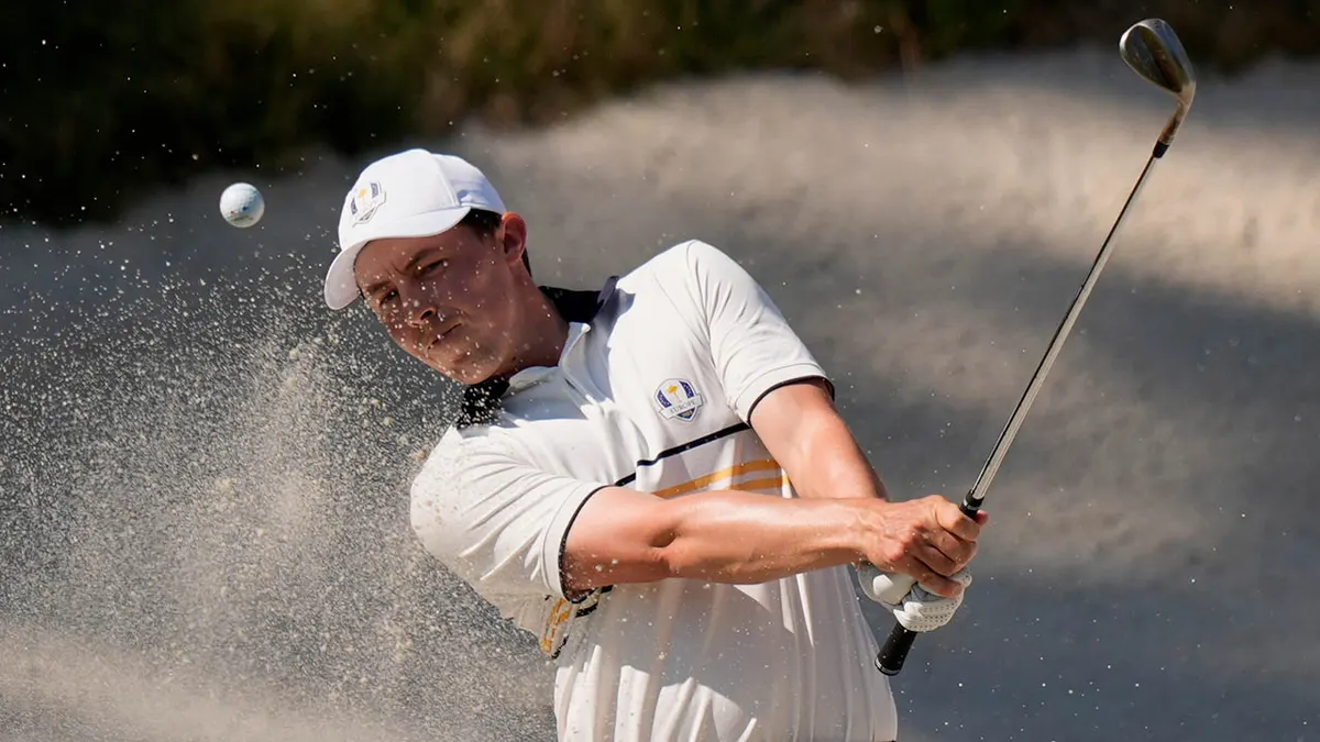 Matthew Fitzpatrick hitting golf ball from bunker on the eighth hole at Ryder Cup
