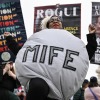 A woman dressed as a mifepristone pill is at rally outside the US Supreme Court on April 2, 2025.