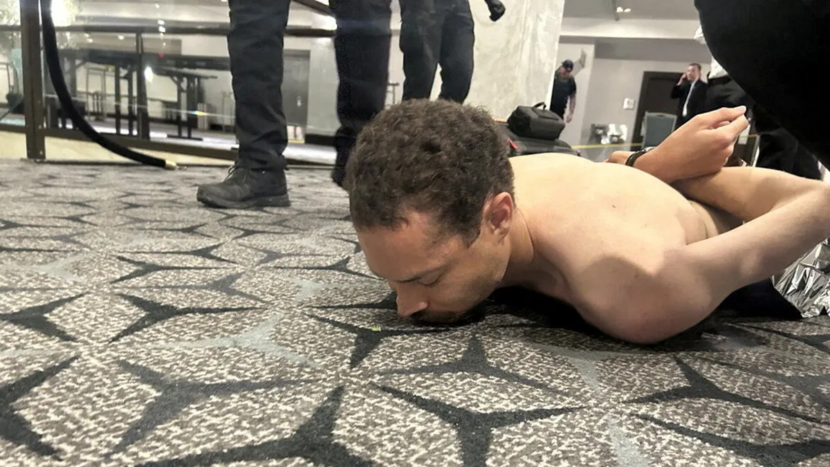Law enforcement personnel detaining Cole Tomas Allen in Washington, D.C.
